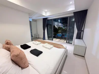 a bedroom with a white bed and a large window at Stunning 3 Bedroom pool villa in Ban Thalat Choeng Thale
