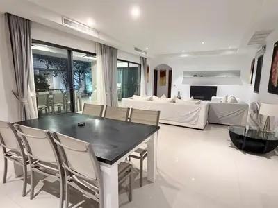 a living room with a table and chairs and a bed at Stunning 3 Bedroom pool villa in Ban Thalat Choeng Thale
