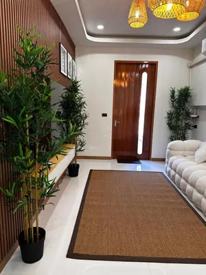 a living room with a couch and potted plants at Patong Relax Home in Patong Beach