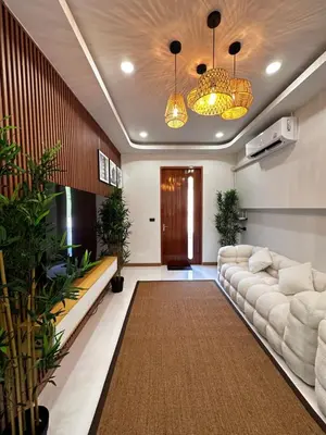 a living room with a couch and some plants at Patong Relax Home in Patong Beach