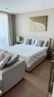 a bedroom with a large bed and a couch at 1 bedroom apartment Laguna bangtao in Laguna Phuket
