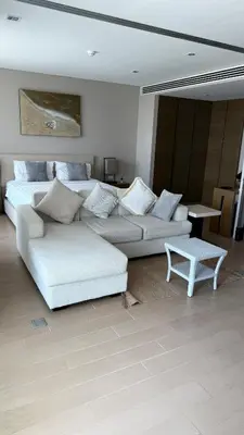 a living room with a white couch and a table at 1 bedroom apartment Laguna bangtao in Laguna Phuket