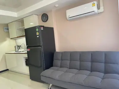 a living room with a couch and a refrigerator at Rawai Beach Condom in Ban Saiyuan (1)