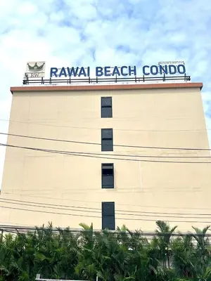 a building with a sign on top of it at Rawai Beach Condom in Ban Saiyuan (1)