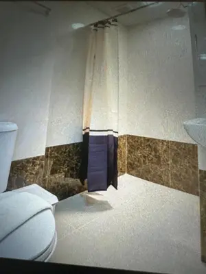 a bathroom with a toilet and a shower curtain at Rawai Beach Condom in Ban Saiyuan (1)