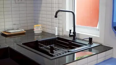 a kitchen counter with a sink and a window at MSP house bangtao in Ban Thalat Choeng Thale