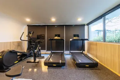 a gym with two exercise bikes and a treadmill at C263 Brand New Condo Near Lake & Nai Harn Beach in Rawai Beach