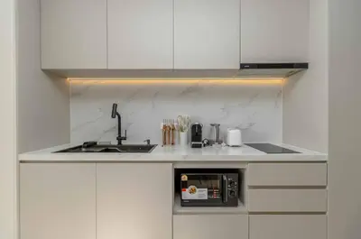 a white kitchen with a sink and a microwave at C263 Brand New Condo Near Lake & Nai Harn Beach in Rawai Beach