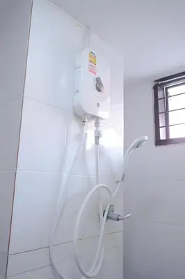 a white shower in a bathroom with a hose at xx GO INN Patong Jangceylon - โกอินน์ ป่าตอง in Patong Beach