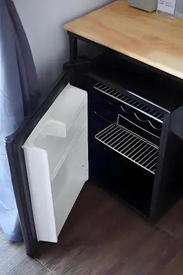 a refrigerator with its door open next to a counter at xx GO INN Patong Jangceylon - โกอินน์ ป่าตอง in Patong Beach