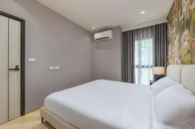 a white bedroom with a bed and a window at Vela 1BR Suite — The Title Legendary BangTao in Bang Tao Beach