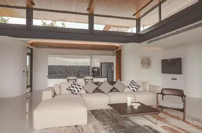 a living room with a couch and a table at Zavaya Luxury Villa by 87Homes in Layan Beach