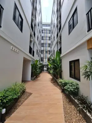 a hallway of an apartment building with plants at VIP Great Hill Airport in Nai Yang Beach