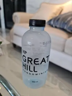 a bottle of water sitting on top of a table at VIP Great Hill Airport in Nai Yang Beach