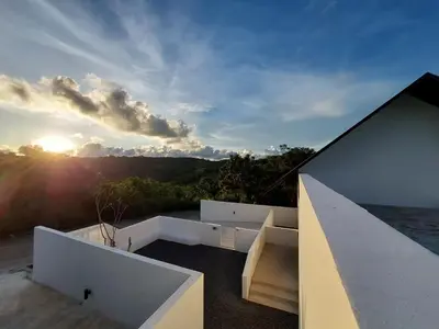 a view of the sun setting over the ocean from a house at Seaview Swimming pool Villa118-1 in Ban Ao Makham