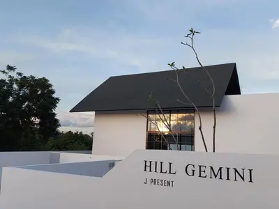 a white building with a black roof and a window at Seaview Swimming pool Villa118-1 in Ban Ao Makham