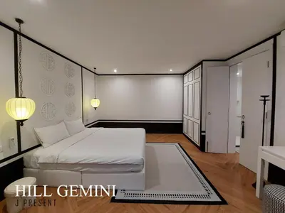a bedroom with a white bed and a table at Wild Seaview Swimming pool Villa118 in Phuket Town