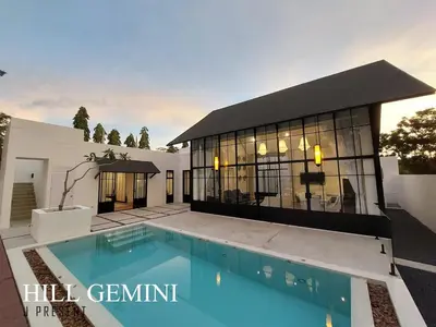 a house with a swimming pool in front of a building at Wild Seaview Swimming pool Villa118 in Phuket Town