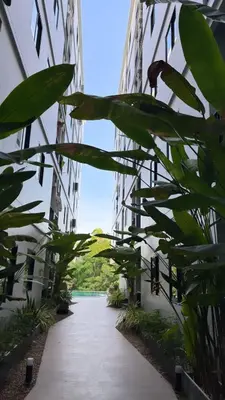 a hallway of an apartment building with green plants at Апартаменты VIP Great Hill Най - Янг in Nai Yang Beach