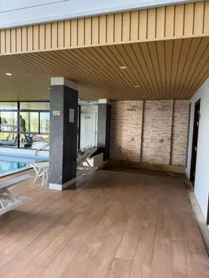a large room with a pool and a wooden floor at Апартаменты VIP Great Hill Най - Янг in Nai Yang Beach