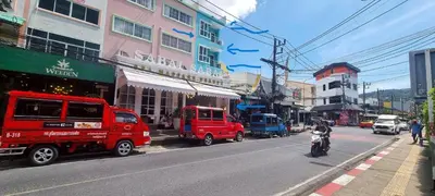 a busy city street with cars and a person on a motorcycle at Bedroom301 Kata Beach Phuket in Kata Beach