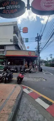 a city street with a building with a driving garage at Bedroom301 Kata Beach Phuket in Kata Beach