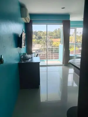 a kitchen with blue walls and a large window at Bedroom301 Kata Beach Phuket in Kata Beach