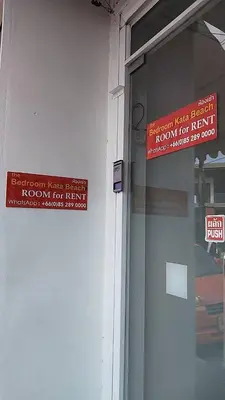 a red sign on the side of a building at Bedroom401 Kata Beach Phuket in Kata Beach