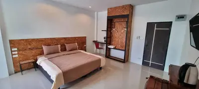a bedroom with a large bed and a bathroom at Sawadee632,Naiharn&Rawai Beach Phuket in Phuket Town