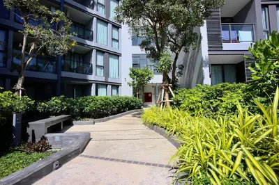 a sidewalk in front of a building with plants at Serenity 2bd apartments in Cassia in Laguna Phuket