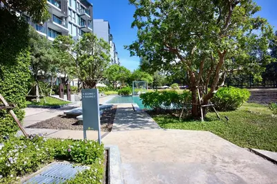 a sign in a park next to a building at Serenity 2bd apartments in Cassia in Laguna Phuket