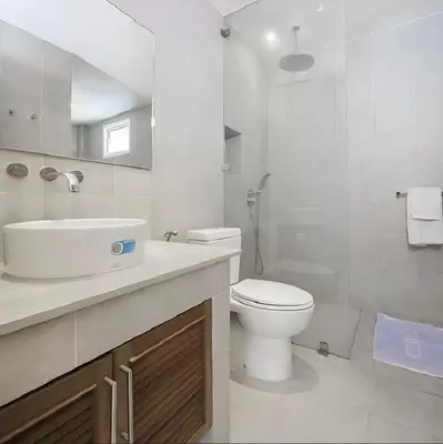 a white bathroom with a toilet and a sink at Euphoria Property in Kamala Beach