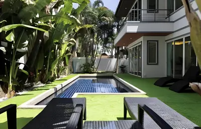 a backyard with a swimming pool and a house at Euphoria Property in Kamala Beach