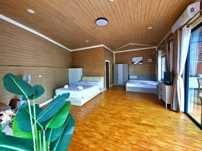 a large room with two beds and a tv at Cocoloco Pool Villa Ao Nang in Ao Nang