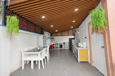 a kitchen with white chairs and a table and a counter at Cocoloco Pool Villa Ao Nang in Ao Nang