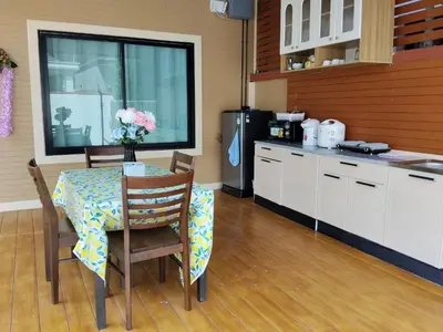 a kitchen with a table with chairs and a refrigerator at Cocoloco Pool Villa Ao Nang in Ao Nang