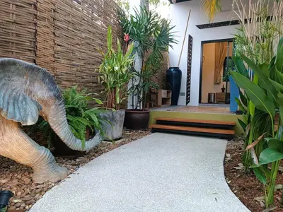 an elephant statue in front of a house with plants at Studio in Phuket Nai Harn in Rawai Beach