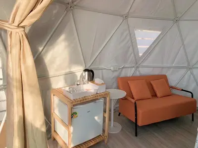 a room with a chair and a sink in a yurt at Seadome Kohyaoyai Resort & Restaurant