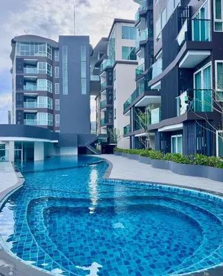 a swimming pool in front of some apartment buildings at Luxury 2 Person Apartment in Heart of Phuket 2 in Ban Ket Ho