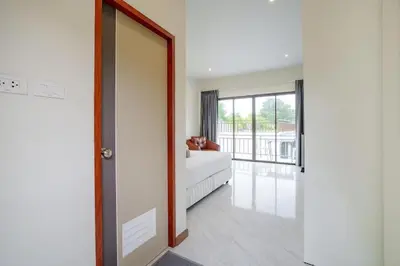 a living room with a couch and a mirror at 1 bedroom apartment - 2 min to the Nai Harn beach in Rawai Beach