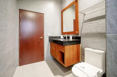 a bathroom with a toilet and a sink and a mirror at 1 bd Villa - 2 minutes to the Nai Harn beach A101, A102 in Rawai Beach