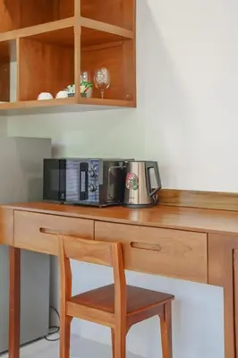 a wooden desk with a microwave and a coffee maker on it at 1 bd Villa - 2 minutes to the Nai Harn beach A101, A102 in Rawai Beach