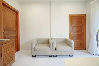 a living room with two chairs and a door at 1 bd Villa - 2 minutes to the Nai Harn beach A101, A102 in Rawai Beach
