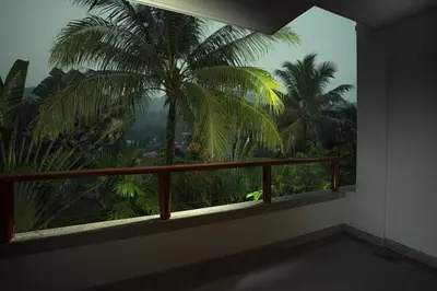 a room with a window with a view of palm trees at Apartment 100 м2, Naithon beach in Phuket
