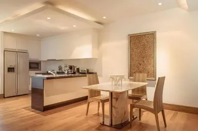a kitchen and dining room with a table and chairs at Apartment 100 м2, Naithon beach in Phuket