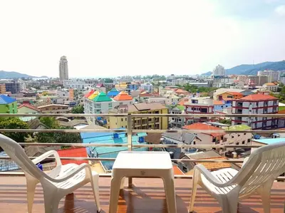 two chairs and a table on a balcony with a city at C257 Studio Seaview Near Beach Pool & Gym View in Patong Beach