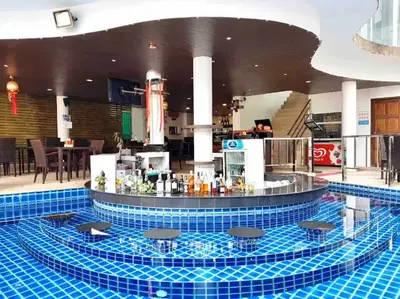 a pool with a bar in the middle of a building at C257 Studio Seaview Near Beach Pool & Gym View in Patong Beach