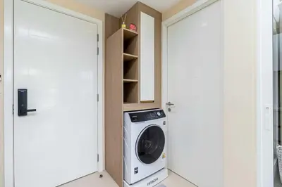 a washing machine in a room next to a door at C261 Work Play & Stay City 1BR Condo Poo l& Gym in Kathu