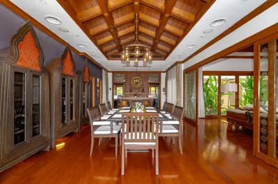 a dining room with a long table and chairs at Royal Legacy Golf Private Villa in Rawai Beach