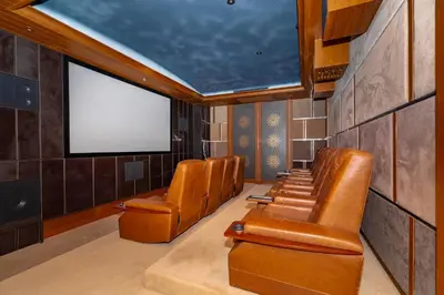 a waiting room with leather chairs and a screen at Royal Legacy Golf Private Villa in Rawai Beach
